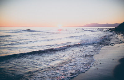 Scenic view of sea against clear sky during sunset