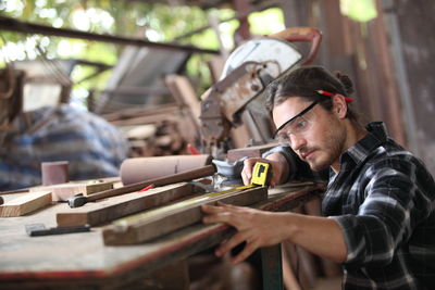 Portrait of man working on wood