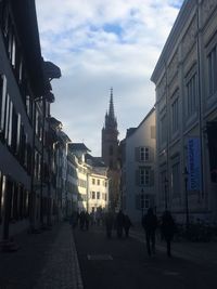 Buildings in city against cloudy sky