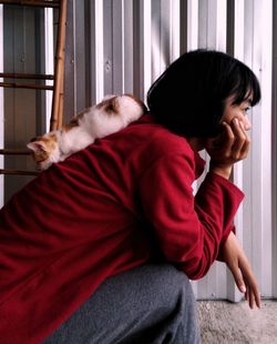 Side view of a boy sitting at home