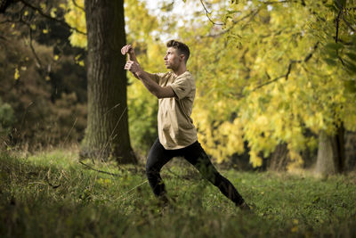 Young man dancing on grass