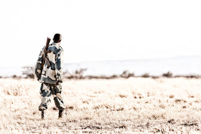 Rear view of man on field