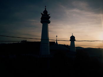 Low angle view of lighthouse against cloudy sky