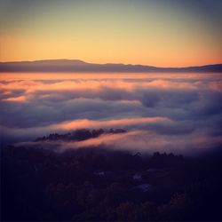 Scenic view of mountains against sky at sunset