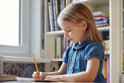 Girl holding book at home