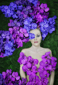 Portrait of woman with purple hydrangea flowers