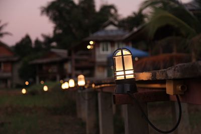 Close-up of illuminated lighting equipment on building