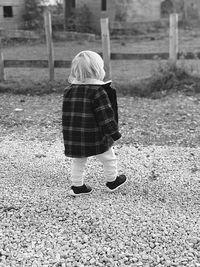 Rear view of girl standing on field