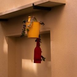 Close-up of electric lamp hanging on wall in building