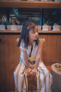 Cute asian little girl sit chair