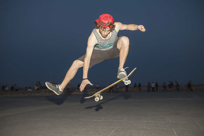 Young skateboarder flipping his board