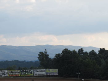 View of sign on mountain against sky