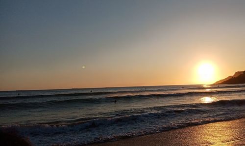 Scenic view of sea against clear sky during sunset