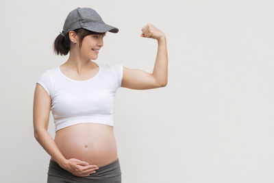 Young woman standing against white background