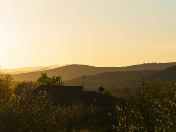 Scenic view of silhouette mountains against sky at sunset