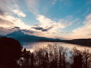 Scenic view of lake against cloudy sky