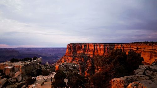 View of rock formations against cloudy sky