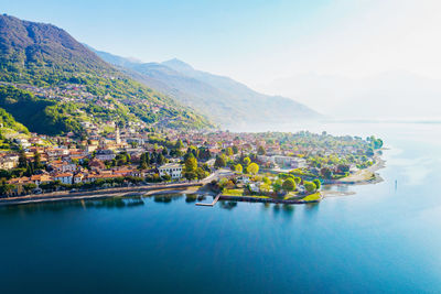 Scenic view of lake by buildings against sky