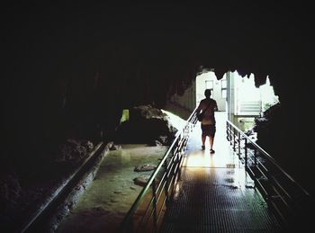 Woman walking in tunnel