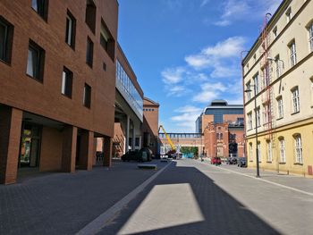 Street amidst buildings in city against sky