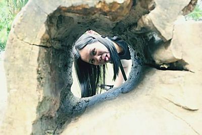 Portrait of man in tree trunk