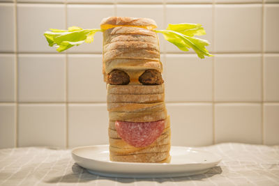 Close-up of breads stacked in plate on table