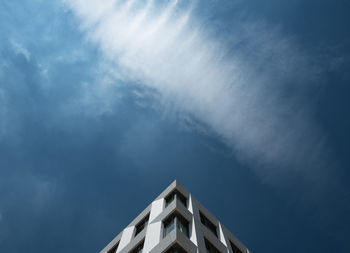 High section of building against blue sky