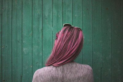 Rear view of woman standing on green leaf