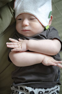 High anlge portrait of cute baby lying on bed at home