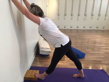 Side view of woman exercising in gym