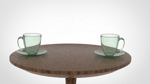 Close-up of drink on table against white background