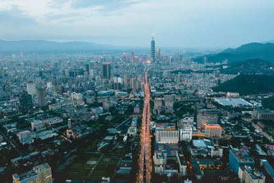 High angle view of illuminated city buildings against sky