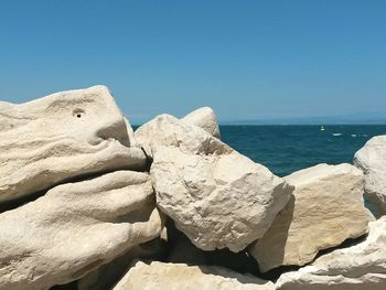 Scenic view of sea against clear blue sky