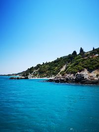 Scenic view of sea against clear blue sky