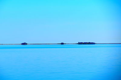 Scenic view of sea against clear blue sky