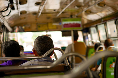 Rear view of people in bus