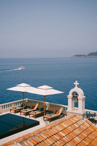 High angle view of swimming pool by sea against clear sky
