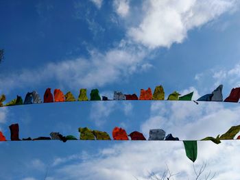 Low angle view of flags against sky