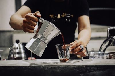 Man preparing food in glass