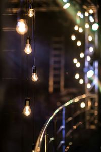 Close-up of illuminated hanging lights in row