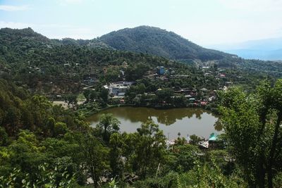 High angle view of lake and houses against sky