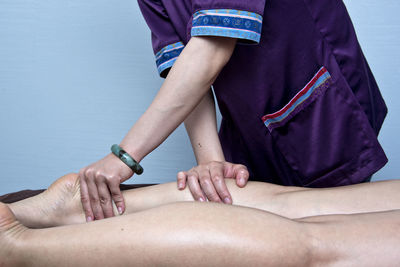 Massage therapist massaging legs