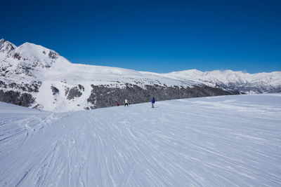 Scenic view of snowcapped mountain against blue sky