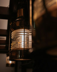 Close-up of illuminated electric lamp on table