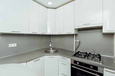 Modern white kitchen with gas stove