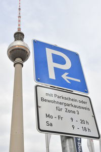 Low angle view of information sign against building