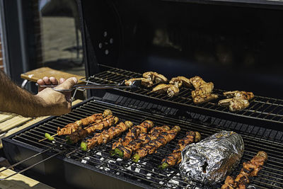 Grilling shashlik on barbecue grill