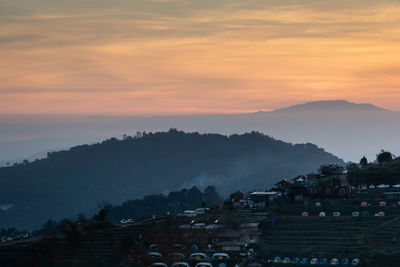 City against sky during sunset