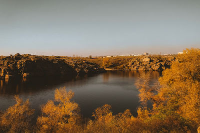 Scenic view of lake against clear sky during autumn