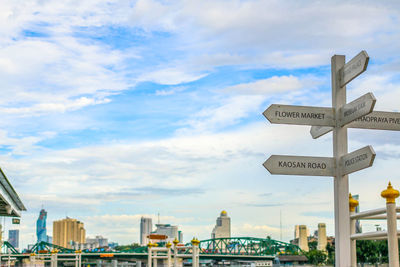 Travel signs by the chao phraya river behind is bangkok view and sky